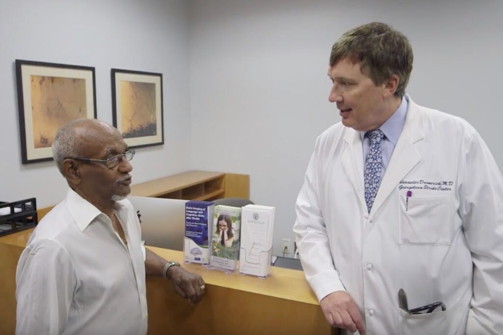 Dr. Dromerick (right) speaking with a patient.