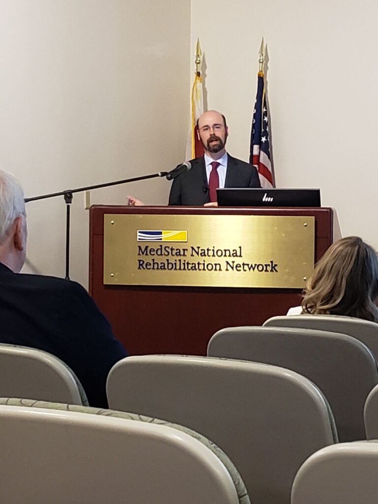 Sean Savitz speaking at the podium.